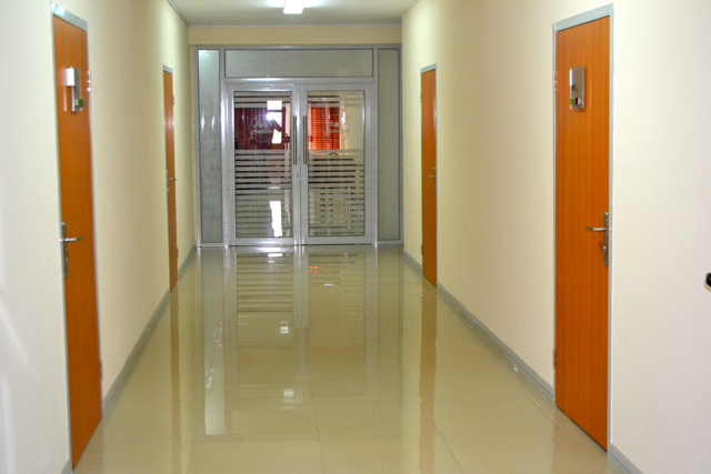 Bright second-floor corridor with orange doors at Vantage Hub